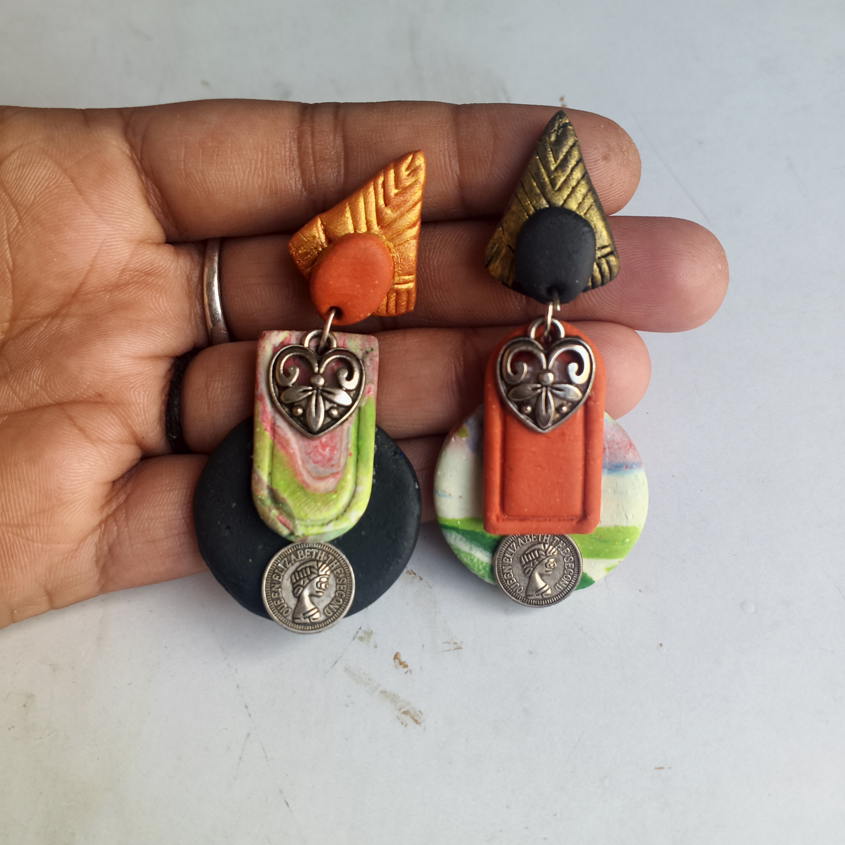 Clay earrings with coin and heart charm detail