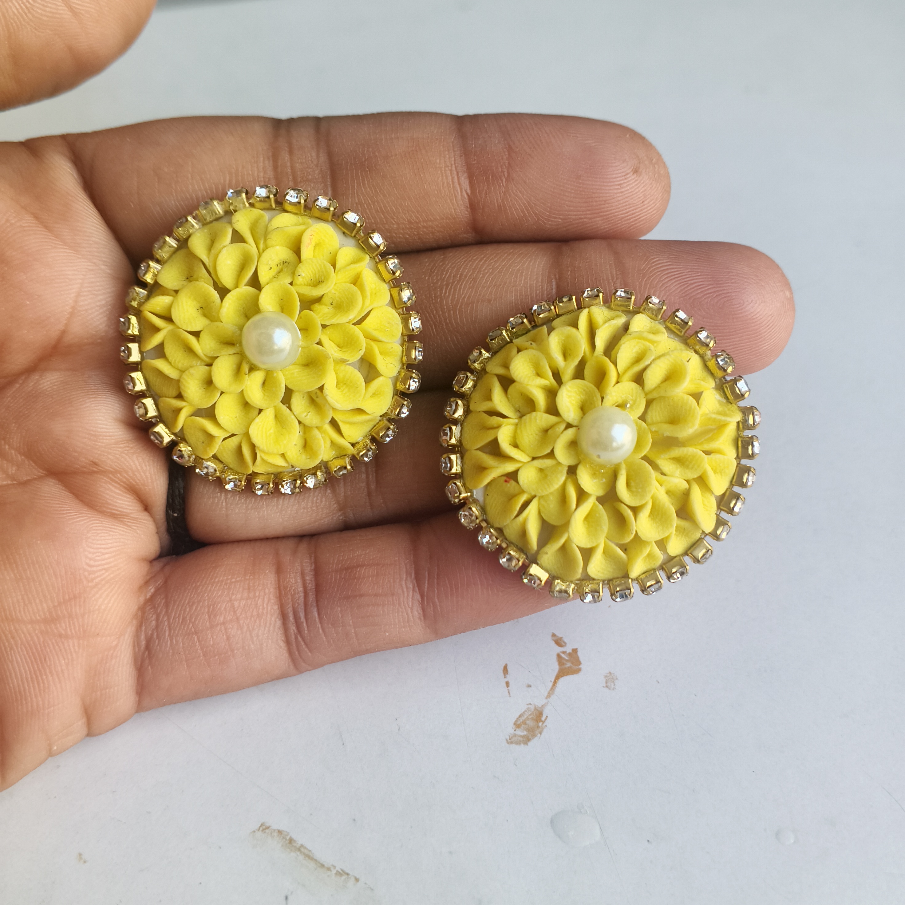 Yellow clay flower stud earrings with rhinestone trim