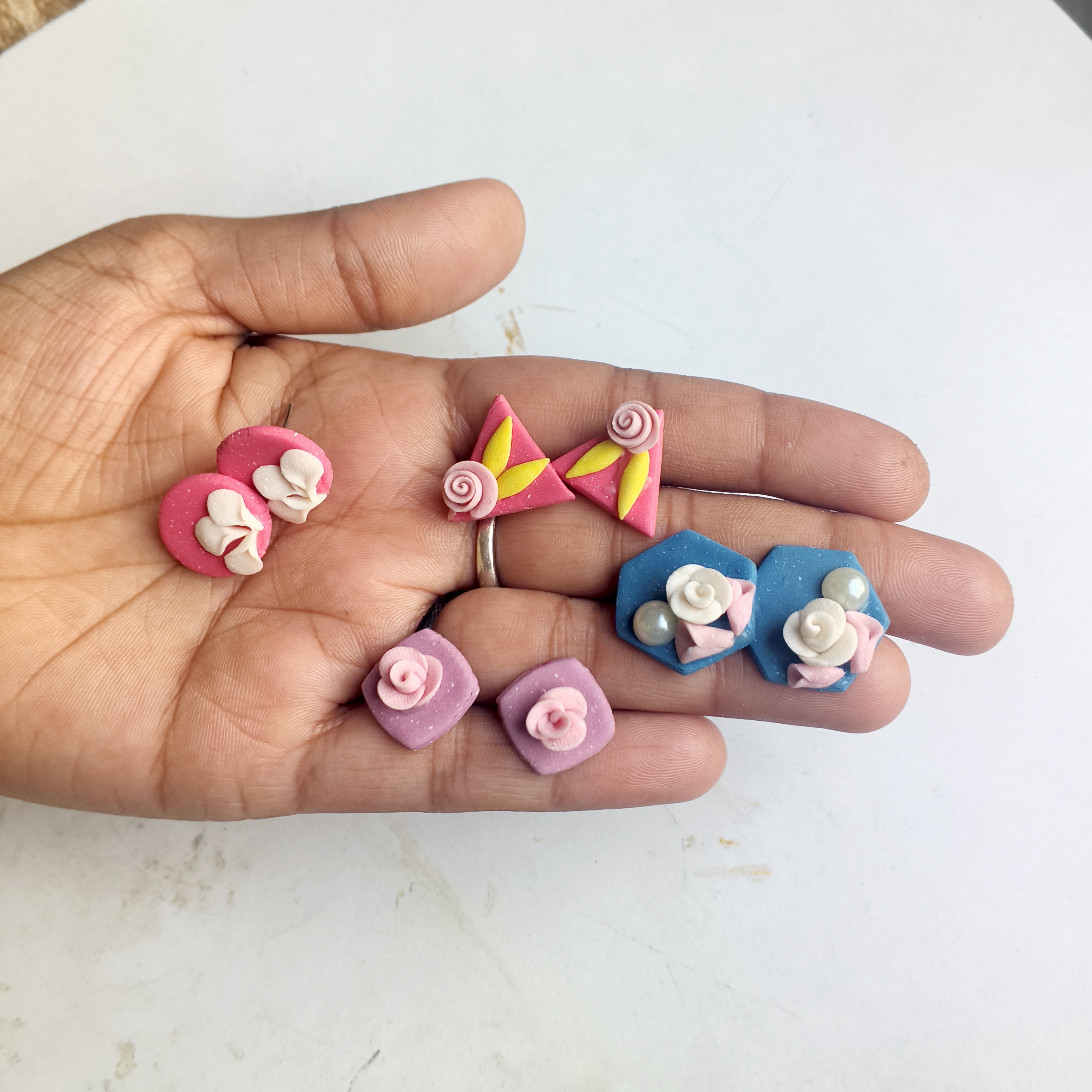 A set of pastel clay rose stud earrings in mixed shapes